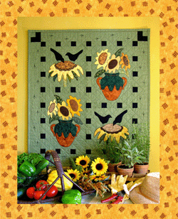 Share The Bounty - “Garden Days” Collection - Pattern - #Q23 - Keeping “uninvited guests” out of the garden is such a futile task. Scarecrows merely provide the birds with a great place to perch while making their dining selections. The only solution I’ve found is to sow a few extra seeds and hope the birds will “share the bounty” with me. Strip piecing, full-size numbered appliqué patterns, and full-size placement sheets make this an easy quilt to construct. Finishing details include blanket stitching on the flowers and satin stitched bird tracks on the border.
